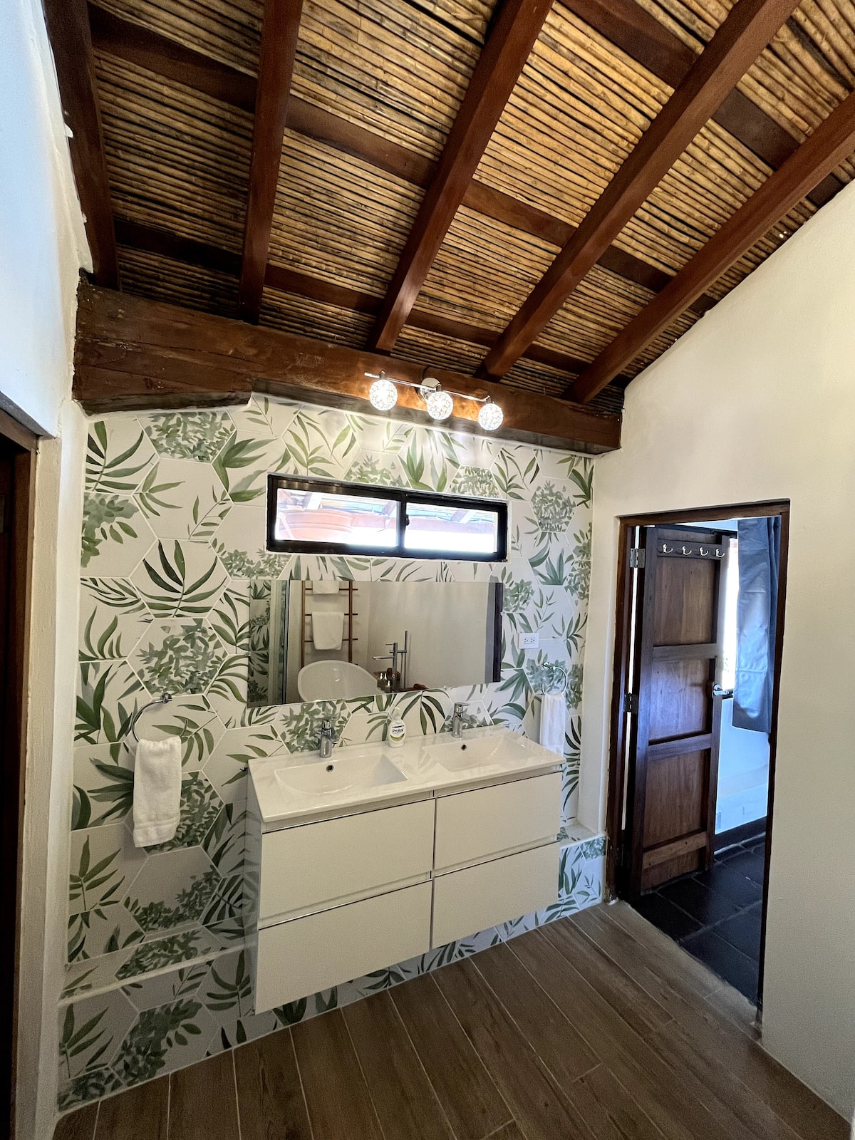 A botanical-tile bathroom