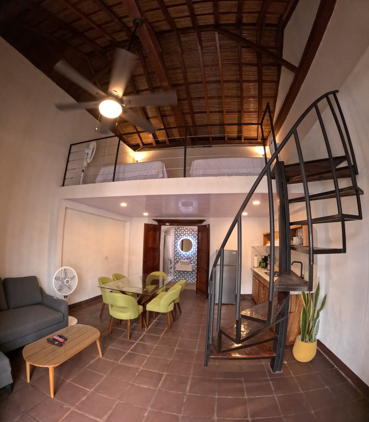 The Downtown Loft — spiral stair and mezzanine bed