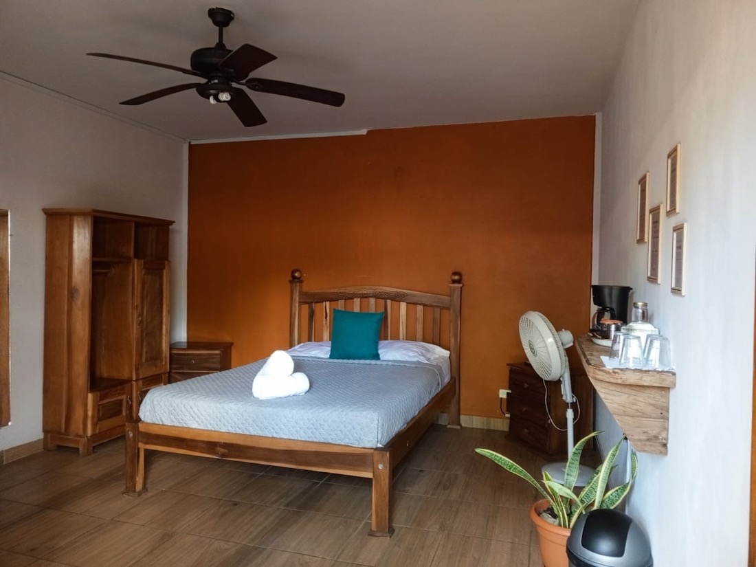 Room Two — queen against a terracotta wall