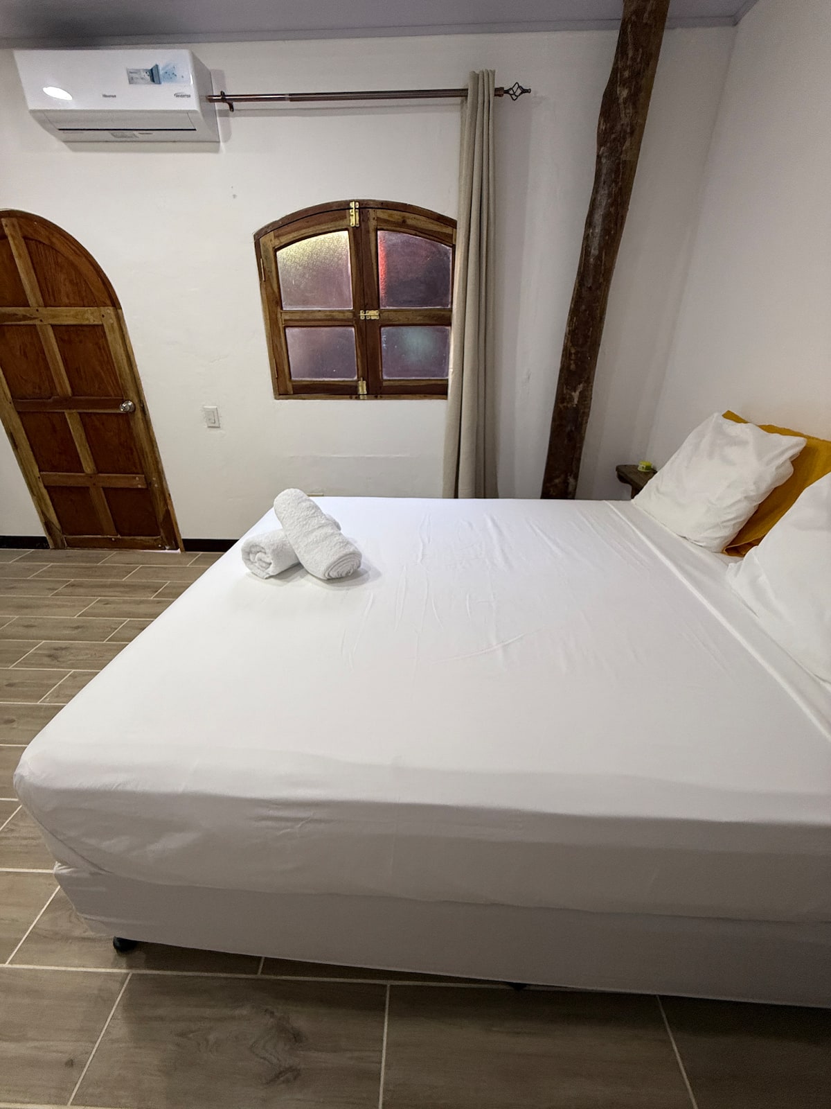 Suite 2 — queen bed by an arched window